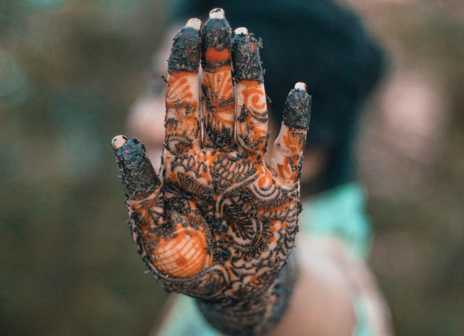 pakistani woman with henna on hands mend